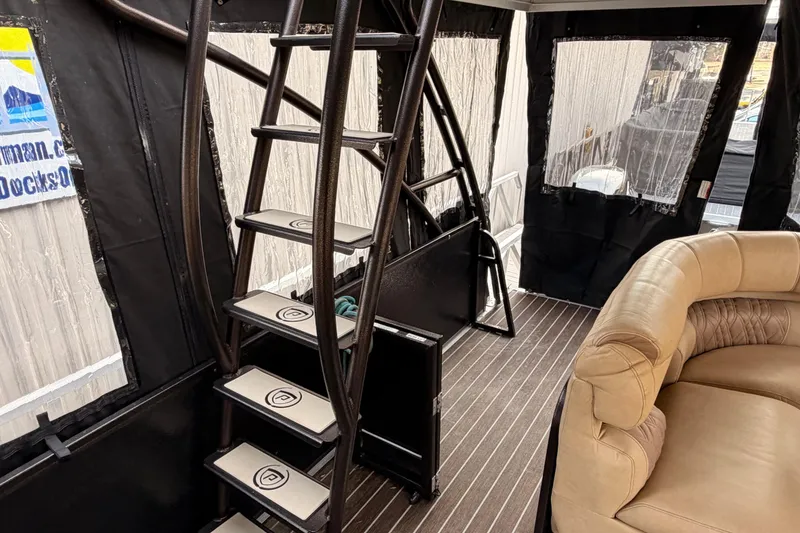 Slide: The Image of 2021 Premier 310 Boundary Waters Rev Top Deck interior with ladder and seating. - 14