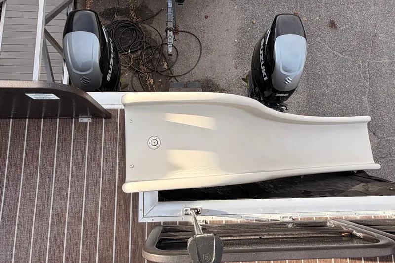 Slide: The Image of Top view of 2021 Premier 310 Boundary Waters Rev Top Deck with slide and twin Suzuki engines. - 16