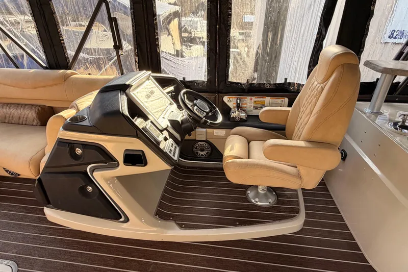 Slide: The Image of Luxurious helm of 2021 Premier 310 Boundary Waters Rev Top Deck boat. - 5