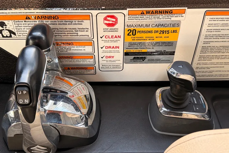 Slide: The Image of Control panel of 2021 Premier 310 Boundary Waters Rev Top Deck with safety warnings. - 7