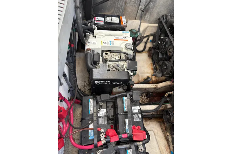 Slide: The Image of Engine compartment of 2005 Sea Ray 300 Sundancer with Kohler power system and batteries. - 16