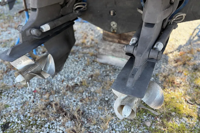 Slide: The Image of Close-up of 2005 Sea Ray 300 Sundancer boat propellers on gravel surface. - 19