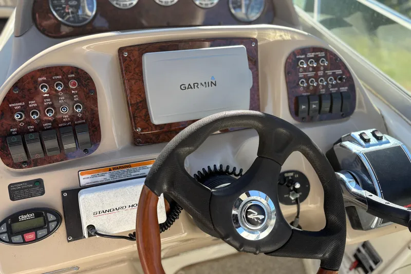 Slide: The Image of 2005 Sea Ray 300 Sundancer helm with Garmin navigation and control panel. - 3