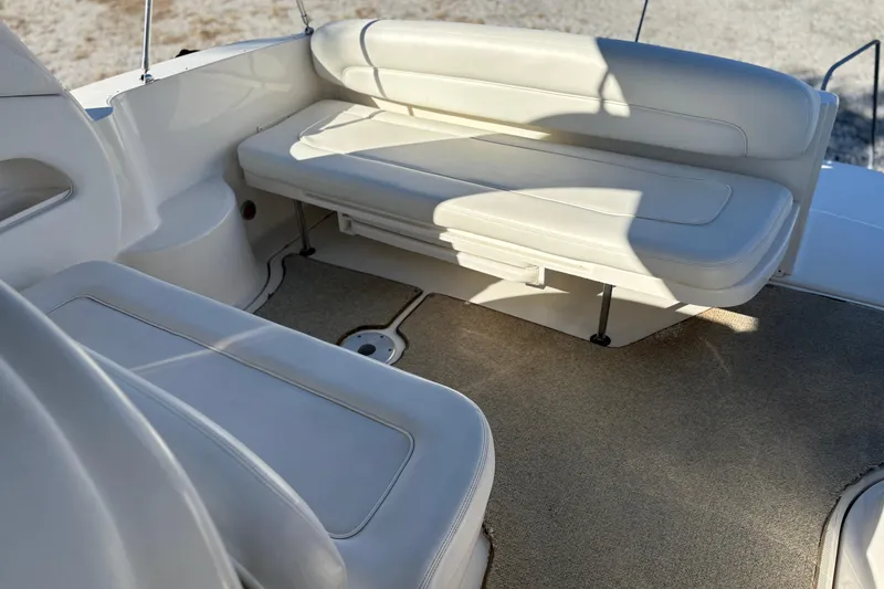 Slide: The Image of 2005 Sea Ray 300 Sundancer boat interior with beige seating and carpet flooring. - 5