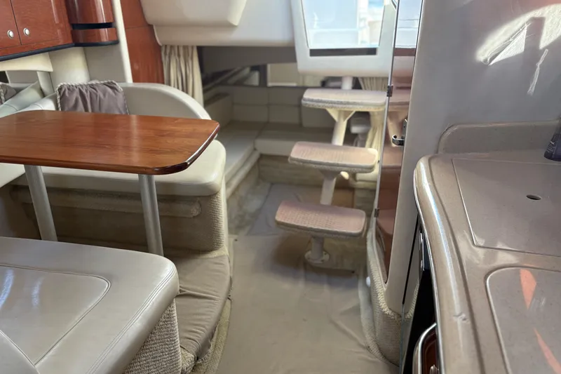 Slide: The Image of Interior of 2005 Sea Ray 300 Sundancer with dining area and steps to cabin. - 9