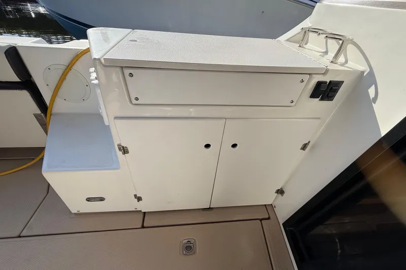 Slide: The Image of 2015 Cutwater 28 boat interior with storage cabinet and utility connections. - 11
