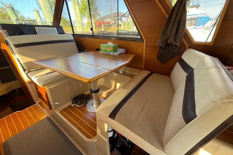 Slide: The Image of Interior of 2015 Cutwater 28 boat with dining area and wooden accents. - 20