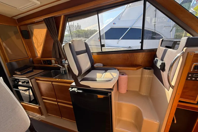 Slide: The Image of Interior of a 2015 Cutwater 28 boat with kitchen and seating area. - 23