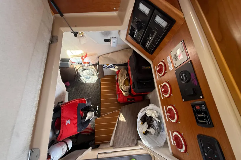 Slide: The Image of Interior of a 2015 Cutwater 28 boat with control panel and storage area. - 26