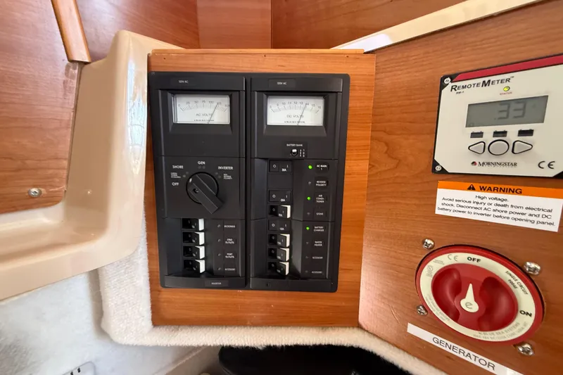 Slide: The Image of Control panel of a 2015 Cutwater 28 boat with voltage meters and generator switch. - 29