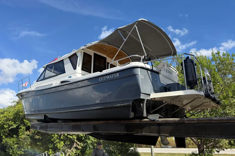 Slide: The Image of 2015 Cutwater 28 boat on trailer under clear blue sky. - 4