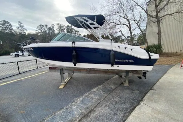 The Image of 2023 Chaparral 210 SSi boat on display, blue and white exterior, parked outdoors. - 1