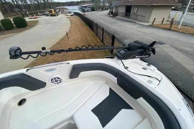 Slide: The Image of 2023 Chaparral 210 SSi boat with MotorGuide trolling motor at a marina. - 10