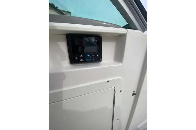 Slide: The Image of 2023 Chaparral 210 SSi boat dashboard with a digital control panel. - 14