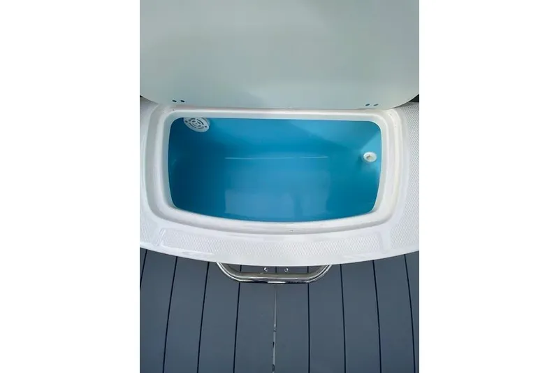 Slide: The Image of 2023 Chaparral 210 SSi boat storage compartment with blue interior. - 16