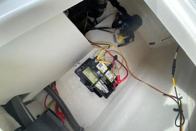 Slide: The Image of Battery compartment of 2023 Chaparral 210 SSi boat with wiring and components. - 18