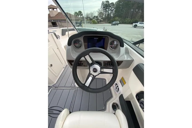 Slide: The Image of 2023 Chaparral 210 SSi boat dashboard with steering wheel and gauges. - 5