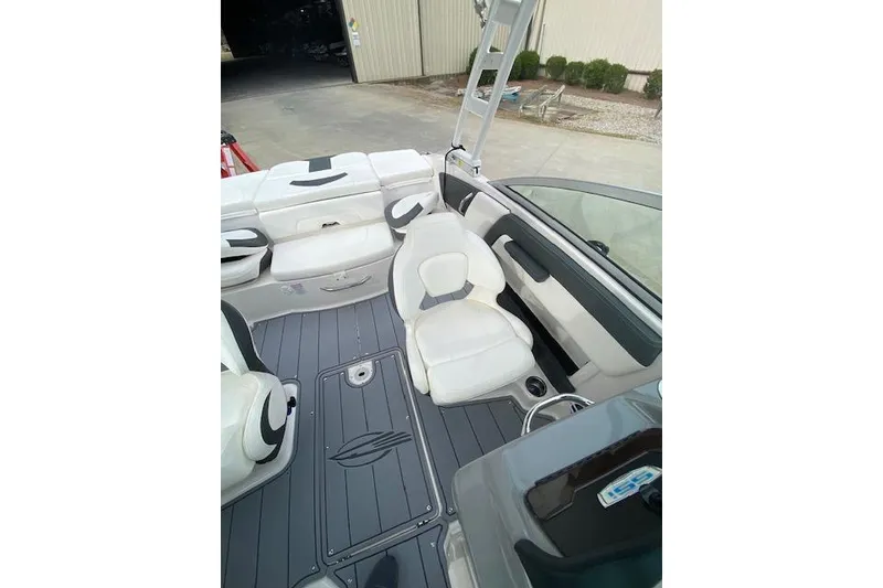Slide: The Image of 2023 Chaparral 210 SSi boat interior with white seating and sleek design. - 7