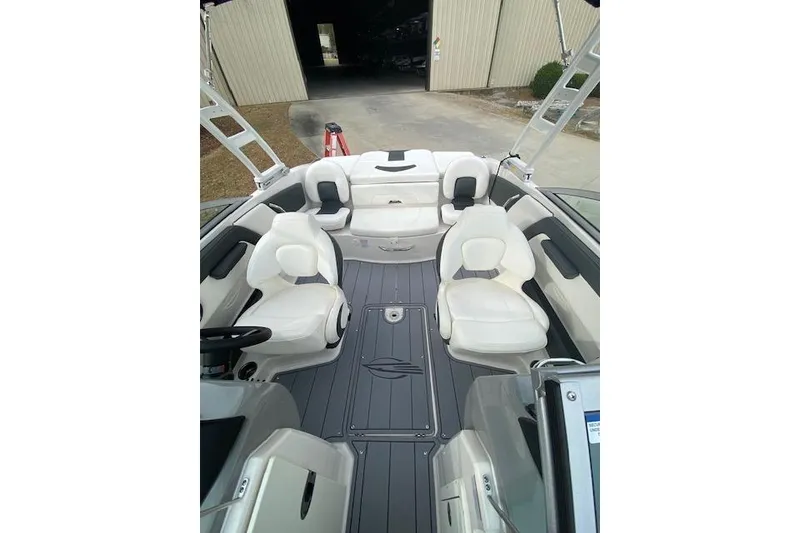 Slide: The Image of 2023 Chaparral 210 SSi boat interior with white seating and sleek design. - 8