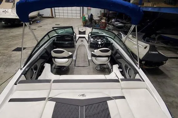 Slide: The Image of 2019 Monterey 218SS Super Sport boat interior with seating and steering wheel in a showroom. - 6