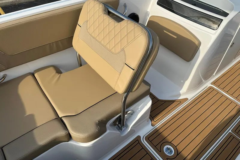 Slide: The Image of 2026 Bayliner VR6 Bowrider OB interior with tan seating and wood-patterned flooring. - 14
