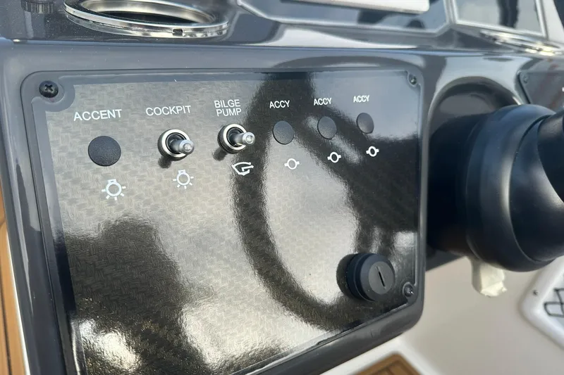 Slide: The Image of Control panel of 2026 Bayliner VR6 Bowrider OB with switches for accent, cockpit, and bilge pump. - 21