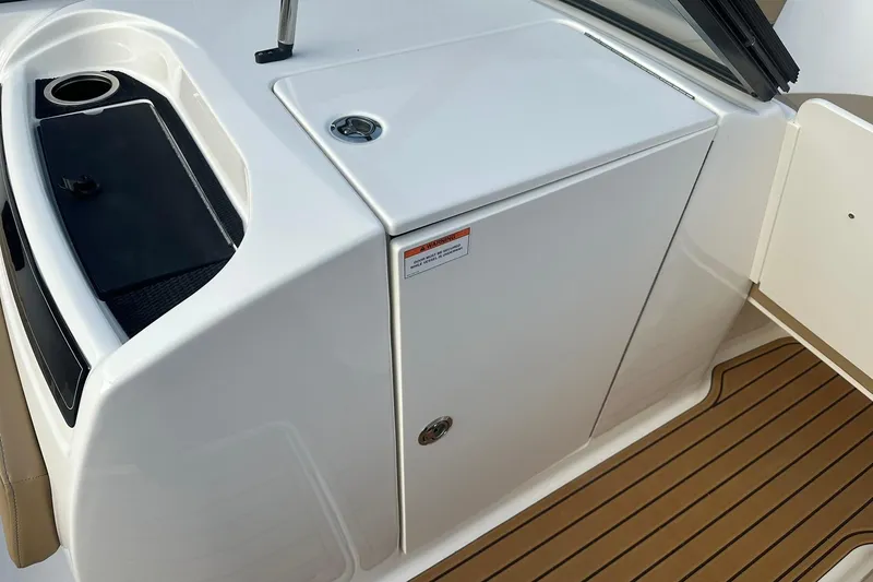 Slide: The Image of 2026 Bayliner VR6 Bowrider OB interior with sleek white cabinetry and wood-textured flooring. - 23