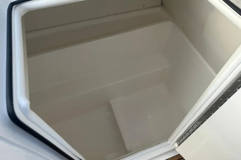 Slide: The Image of 2026 Bayliner VR6 Bowrider OB storage compartment, open and empty. - 24