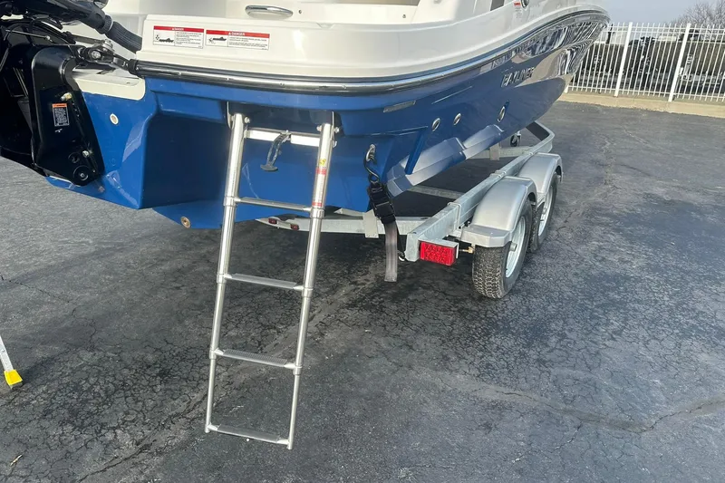 Slide: The Image of 2026 Bayliner VR6 Bowrider OB on trailer with ladder, blue hull. - 28