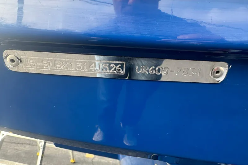Slide: The Image of 2026 Bayliner VR6 Bowrider OB boat identification plate on blue hull. - 29
