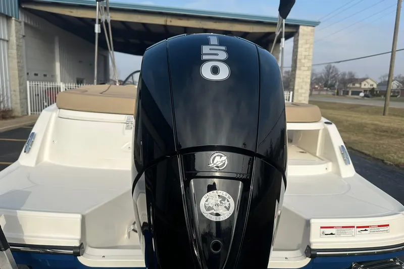 Slide: The Image of 2026 Bayliner VR6 Bowrider OB with 150 HP outboard motor, parked outdoors. - 30