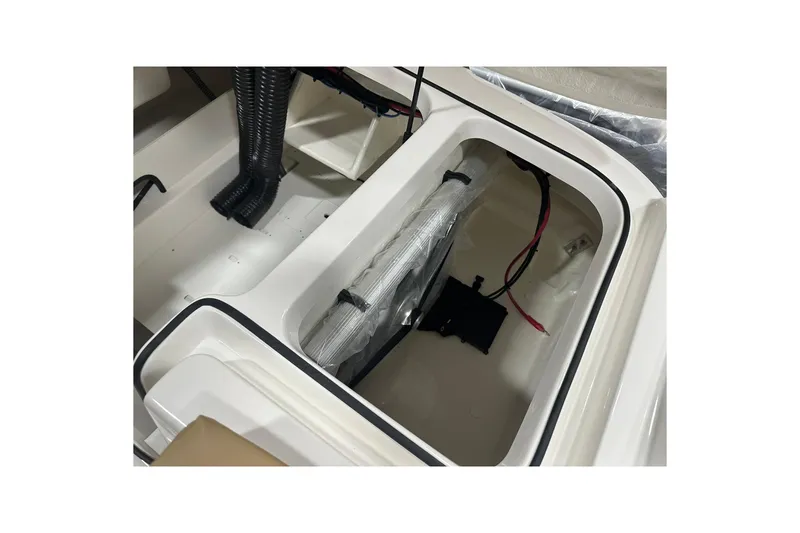 Slide: The Image of 2026 Bayliner VR6 Bowrider OB interior storage compartment with wiring and ventilation. - 31