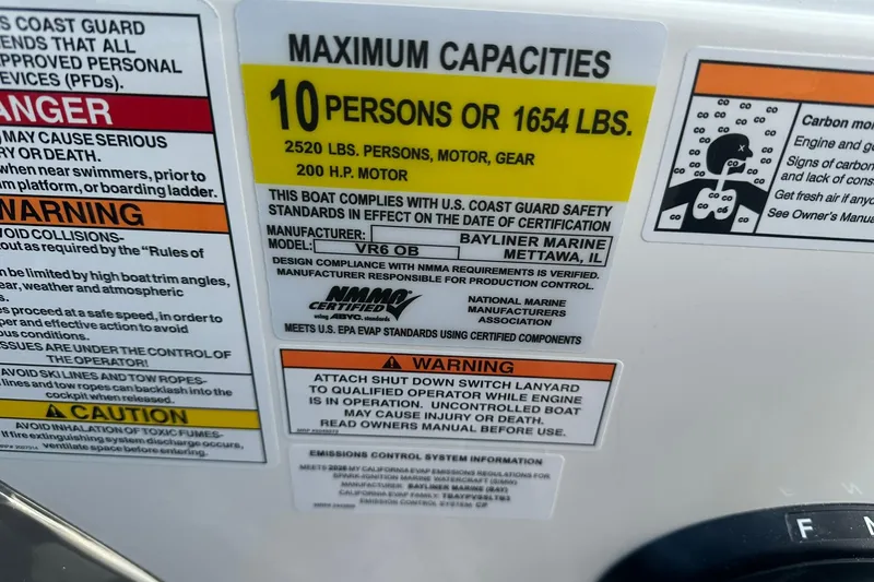 Slide: The Image of Bayliner VR6 Bowrider OB 2026 capacity label, 10 persons or 1654 lbs, safety warnings. - 33