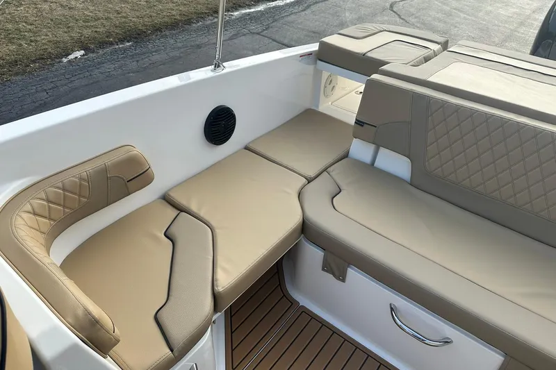 Slide: The Image of 2026 Bayliner VR6 Bowrider OB interior with beige cushioned seating and sleek design. - 9