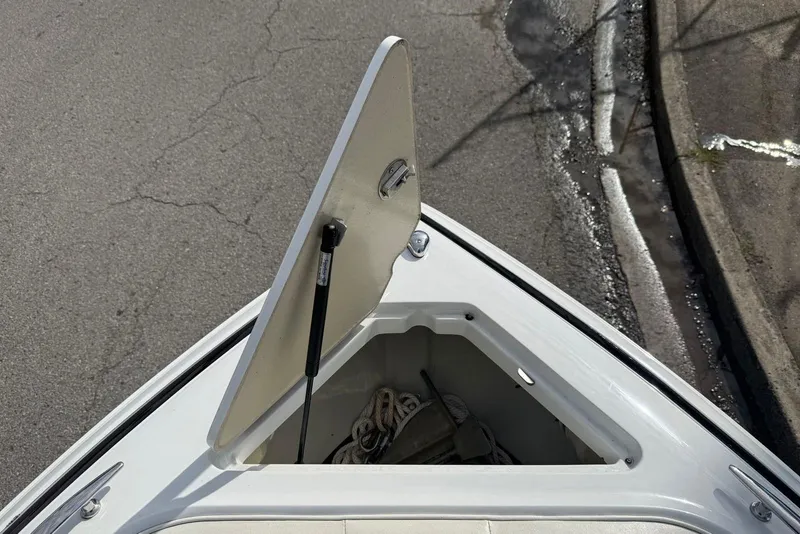 Slide: The Image of Open storage compartment on 2013 Cobalt 232 boat, showing interior details. - 10