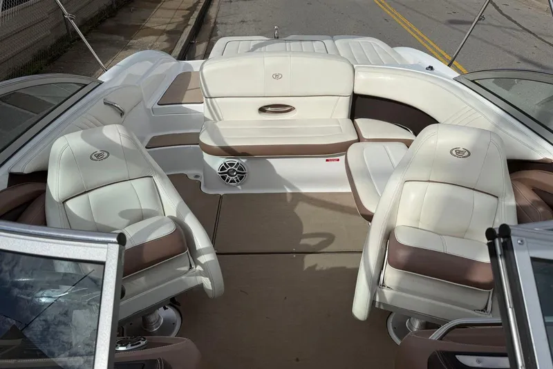 Slide: The Image of Interior of a 2013 Cobalt 232 boat with white and brown seating. - 12