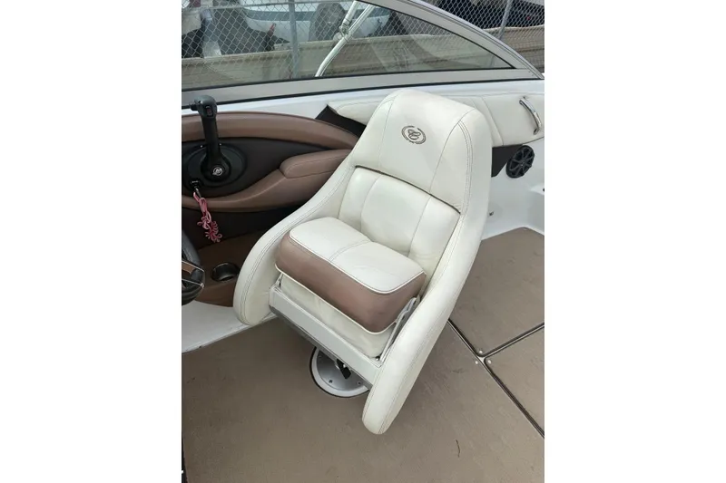 Slide: The Image of 2013 Cobalt 232 boat interior with white and beige leather seat. - 14