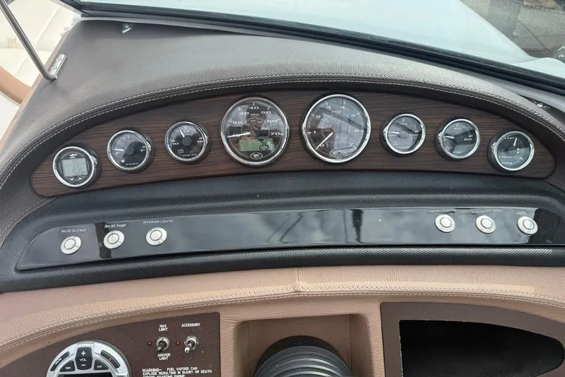 Slide: The Image of Dashboard of a 2013 Cobalt 232 boat with gauges and control buttons. - 17