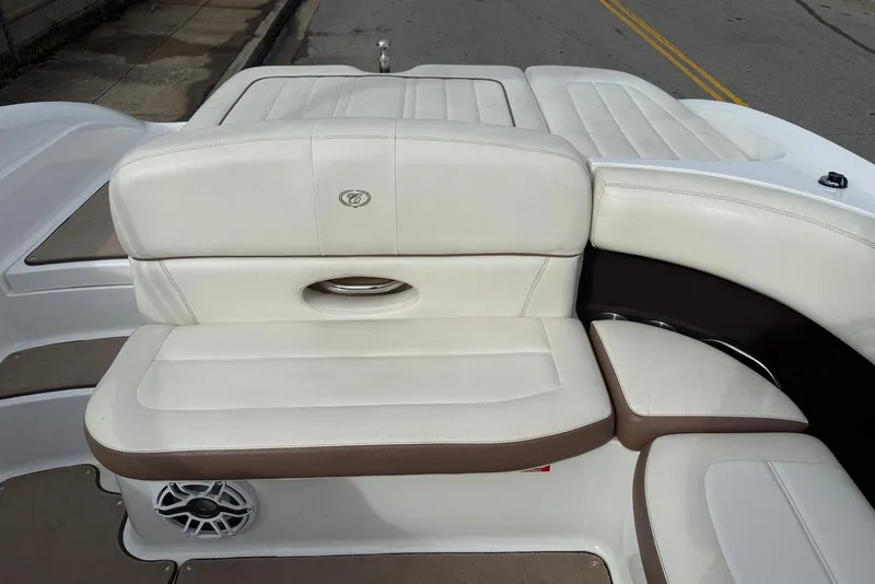 Slide: The Image of 2013 Cobalt 232 boat with white and brown leather seating, featuring a built-in speaker. - 20