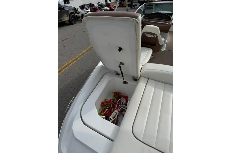Slide: The Image of 2013 Cobalt 232 boat with open storage compartment and colorful ropes. - 22