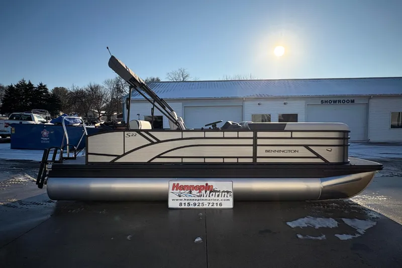 The Image of 2026 Bennington 22 S-One Swingback pontoon boat displayed outdoors near a showroom. - 0