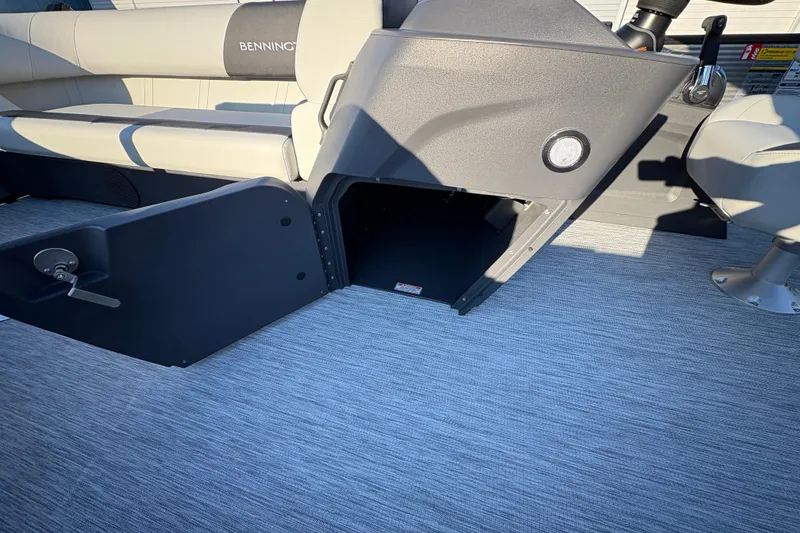 Slide: The Image of 2026 Bennington 22 S-One Swingback interior with open storage compartment and seating. - 12