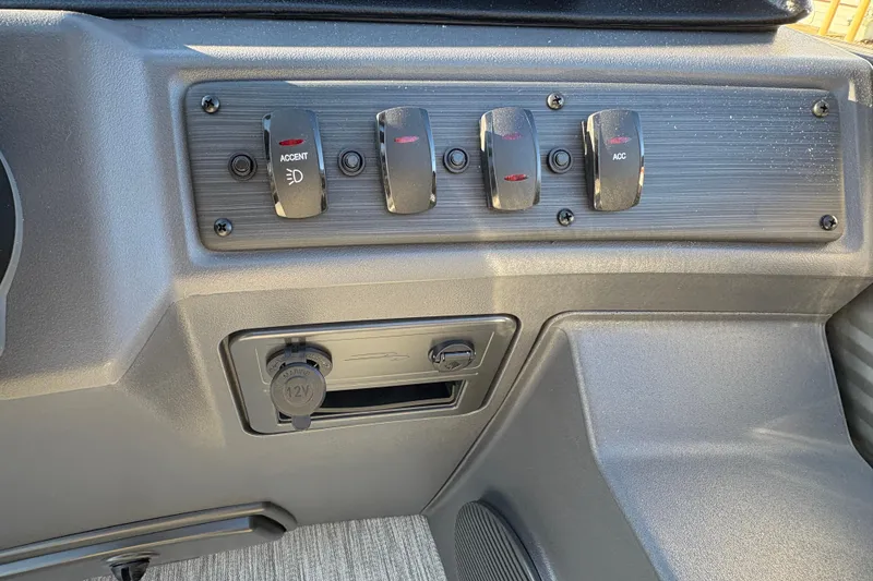 Slide: The Image of Dashboard controls of 2026 Bennington 22 S-One Swingback with switches and 12V outlet. - 14
