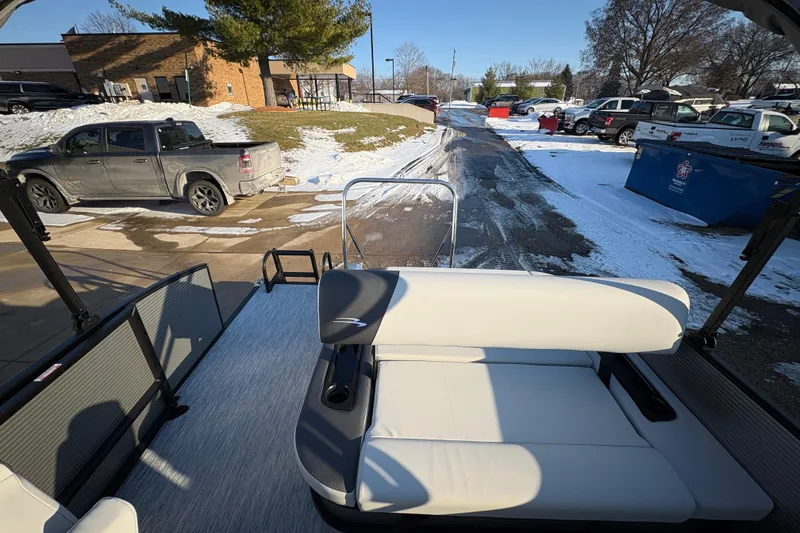 Slide: The Image of 2026 Bennington 22 S-One Swingback boat with white seating, parked in snowy lot. - 17