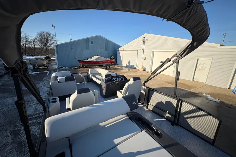 Slide: The Image of 2026 Bennington 22 S-One Swingback pontoon boat with spacious seating, parked outdoors. - 18