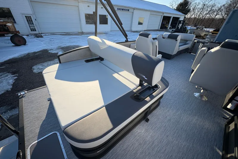 Slide: The Image of 2026 Bennington 22 S-One Swingback pontoon boat with modern seating in a snowy showroom. - 21