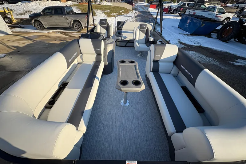 Slide: The Image of 2026 Bennington 22 S-One Swingback pontoon boat interior with plush seating and table. - 6