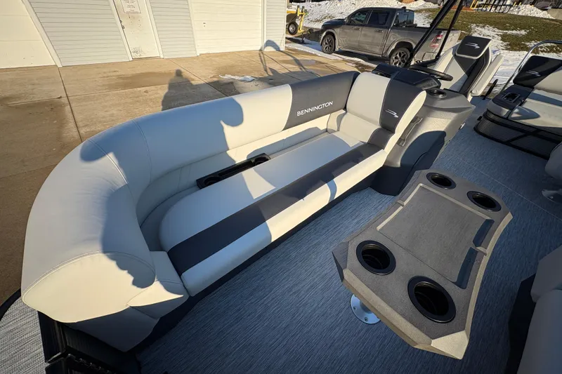 Slide: The Image of 2026 Bennington 22 S-One Swingback boat interior with plush seating and cup holders. - 7