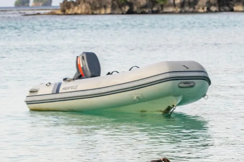 Slide: The Image of Manufacturer Provided Image: Highfield UltraLite 290 inflatable boat, 2025 model, floating on calm water. - 2