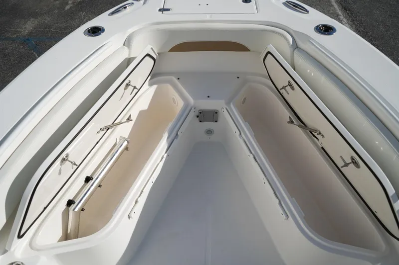 Slide: The Image of 2021 Edgewater 230CC boat with open storage compartments on deck. - 10